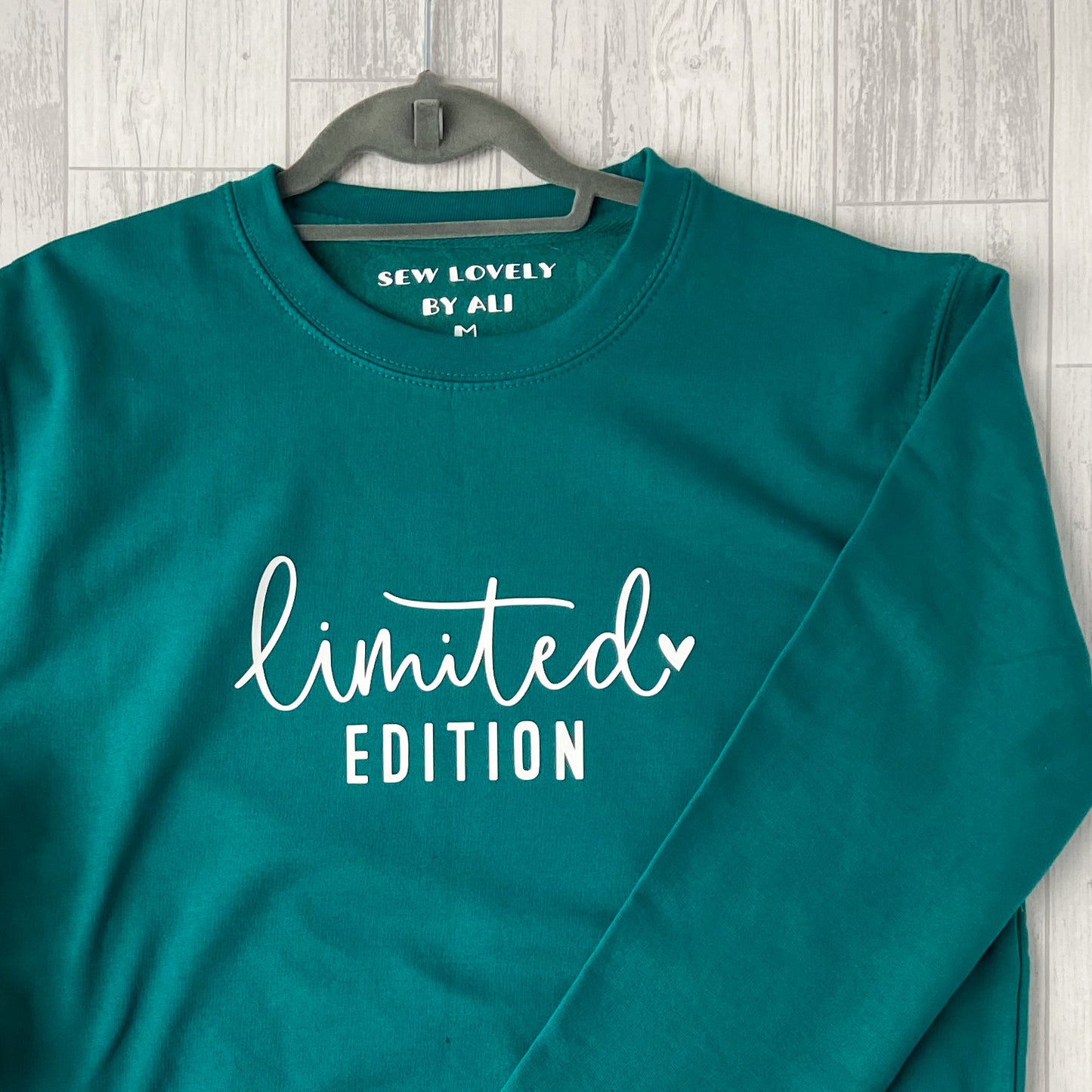 Jade crew neck sweatshirt with white wording that reads 'Limited Edition'.