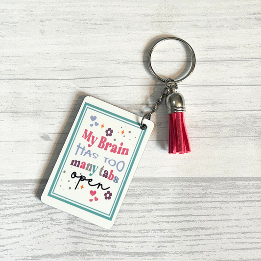 Rectangle MDF Keychain with white gloss layer and deign that says 'My Brain Has Too Many Tabs Open'. Comes with coloured tassel and chain.